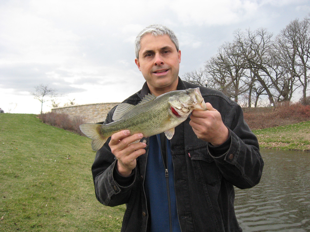 Nick Caralis holding a nice large mouth bass caught at a local pond.